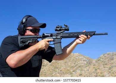 Man Firing Ar-15 Style Rifle At Range