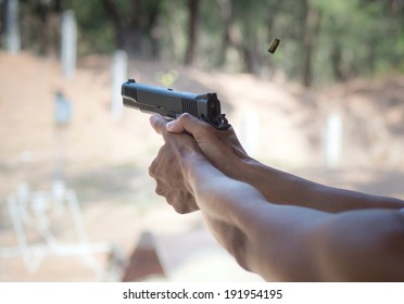 Man Firing Pistol At Firing Range