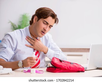 Man With First Aid Kit In The Office