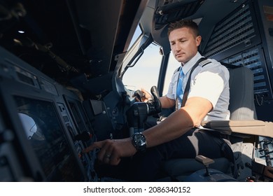 Man First Officer Pressing Button On Airplane Control Panel