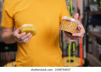 Man Fisherman Choosing Bait In A Fishing Store, Corn For Fish. Close Up