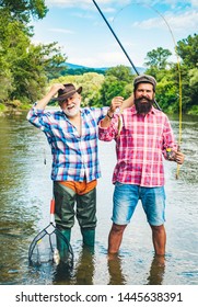 Man Fishing. Men Fishing In River During Summer Day. Father And Son Fishing. Fly Rod And Reel With A Brown Trout From A Stream