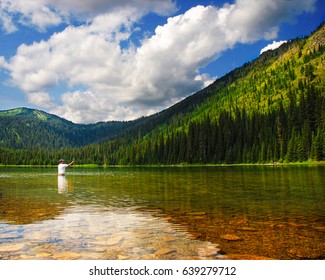 Man Fishing At Moose Lake Near Kalispell And Whitefish, Montana