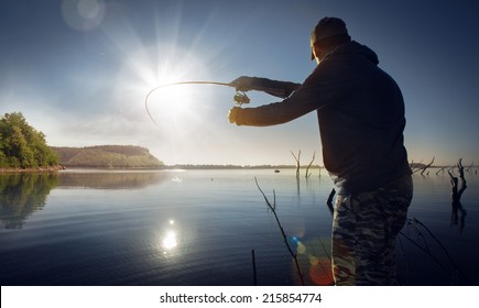 Man Fishing On A Lake 