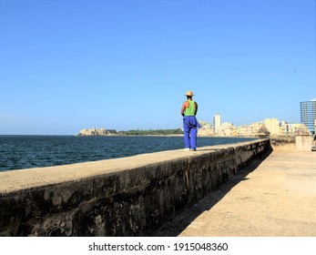 Man fishing on a parapet in Havana, Cuba - Shutterstock ID 1915048360