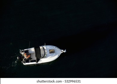 Man Fishing From A Small Boat With An Outboard Motor. View From Above. Little Belt In Denmark.