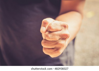 A man fists clenched in anger - Shutterstock ID 482938327