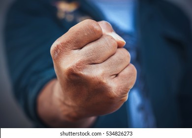 A man fists clenched in anger