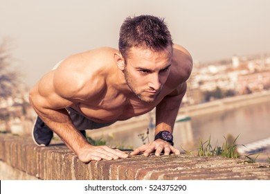 Man Fitness Model Training Pushups Outdoors