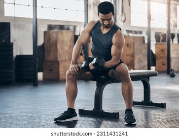 Man, fitness and training with dumbbell at the gym for strong muscle for sport and power. Male athlete, workout and weight lift for exercise with strength at club with bodybuilder for challenge. - Powered by Shutterstock