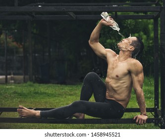 Man fitness yoga drinking and splashing water on him face for fresh. sport healthy people concept.