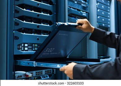 Man fix server network in data center room .