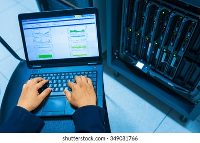 Man fix server network in data center room .