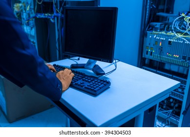 Man fix server network in data center room .