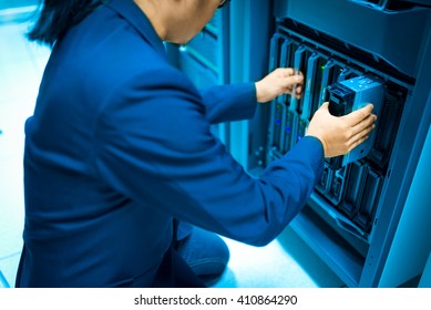 Man fix server network in data center room .