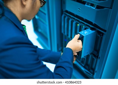 Man fix server network in data center room .