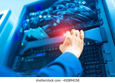 Man fix server network in data center room .