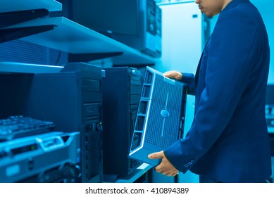 Man fix server network in data center room .