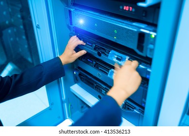 Man fix server network in data center room .