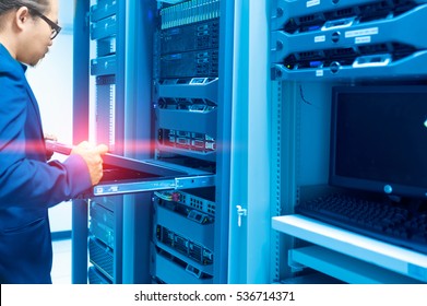 Man fix server network in data center room .