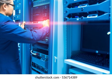 Man fix server network in data center room .