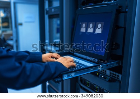 Man fix server network in data center room .