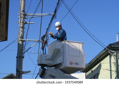 A Man Fixing A Cable For Telecommunication In Saitama, Japan. March 15, 2021.