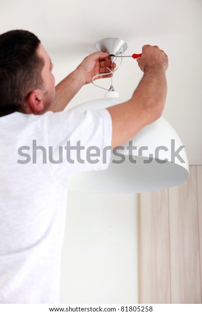 Man Fixing Ceiling Light Stock Photo Edit Now 81805258