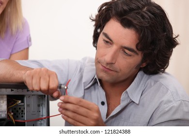 Man Fixing A Hard Drive