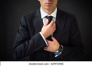 Man Fixing His Tie