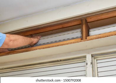 Man Fixing An Old Blind In Its Wooden Box