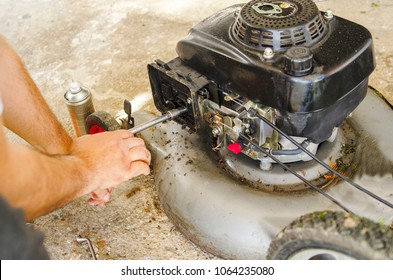 Man Fixing Old Lawn Mower. Close Up On Male Hand Repair With Tool. Manual Job On Machine. 