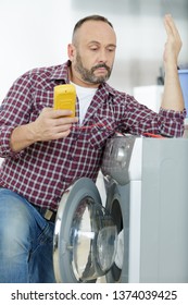 Man Is Fixing A Problem On A Clothes Washer