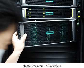 Man fixing server in data center room .                