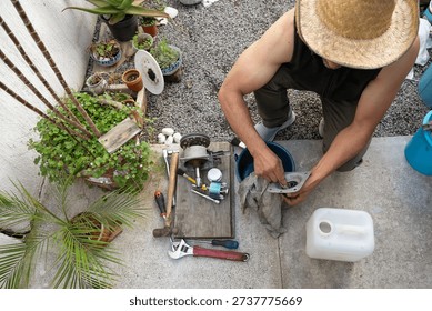 Man Fixing Washing Machine Components in Backyard