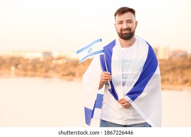 Man With The Flag Of Israel Outdoors