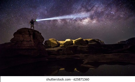 man and flashlight at night
