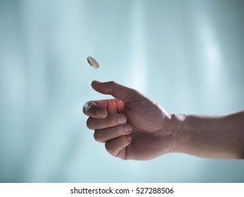 Man Flipping One Pound Coin, Pounds Sterling