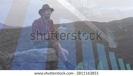 Man flipping pad pages while initiating animated finance charts and down arrow over rocky hills. Notebook, clipboard, outdoor, rugged, ridge, bargraph, data