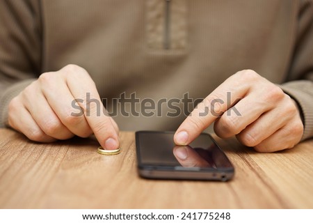 Man is flirting with another woman over mobile phone to go on date without wedding ring. Cheating concept