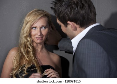 Man Flirting With A Woman Standing At The Wall