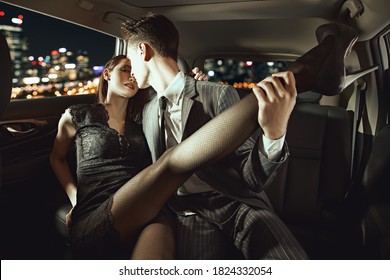 A man flirts with his girlfriend in the car. Love and passion.