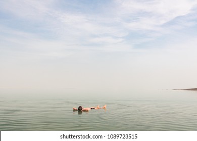 Man Floating On His Back At The Dead Sea In Israel