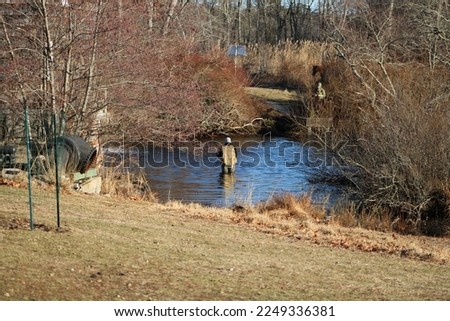 A man fly fishing in the Connetquot River.