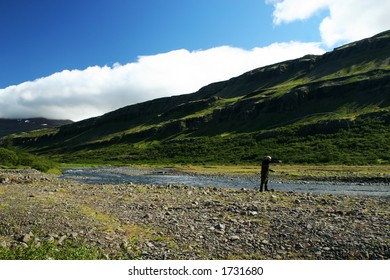 A Man Flyfishing In A Great North Atlantic Salmon River , Casting With The Line In The Air