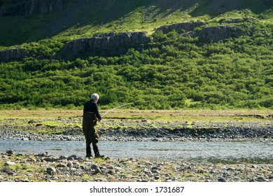 A Man Flyfishing In A Great North Atlantic Salmon River Just Finished Casting The Line