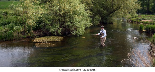 Man Flyfishing The River Eden In Scotland