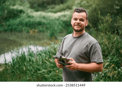 Man flying drone using remote control.