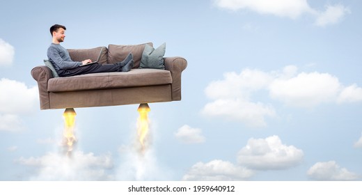 Man flying on a rocket sofa while using a laptop