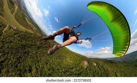 Man flying the paragliding alone at sunny day, adventure concept - Shutterstock ID 2172738501